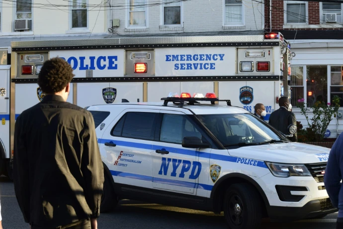 Nypd police vehicles with emergency lights on a street